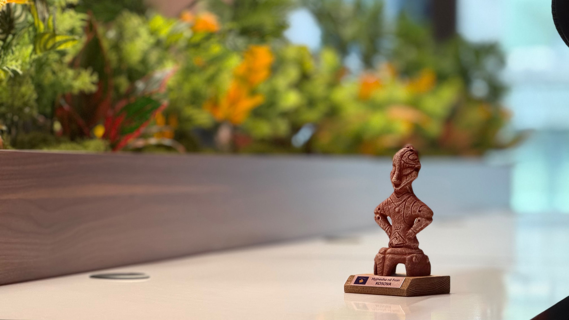 A handmade Kosovar figurine on a desk